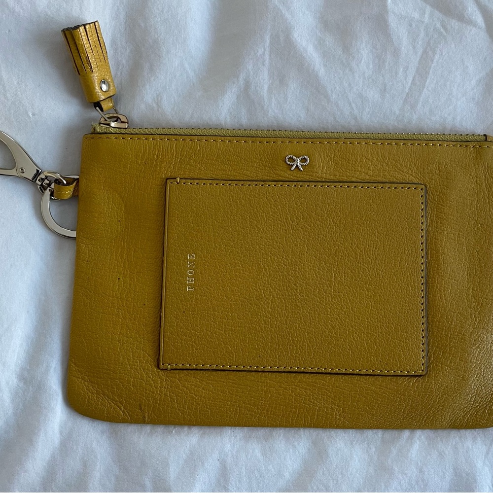 Anna Hindmarch phone clutch in mustard